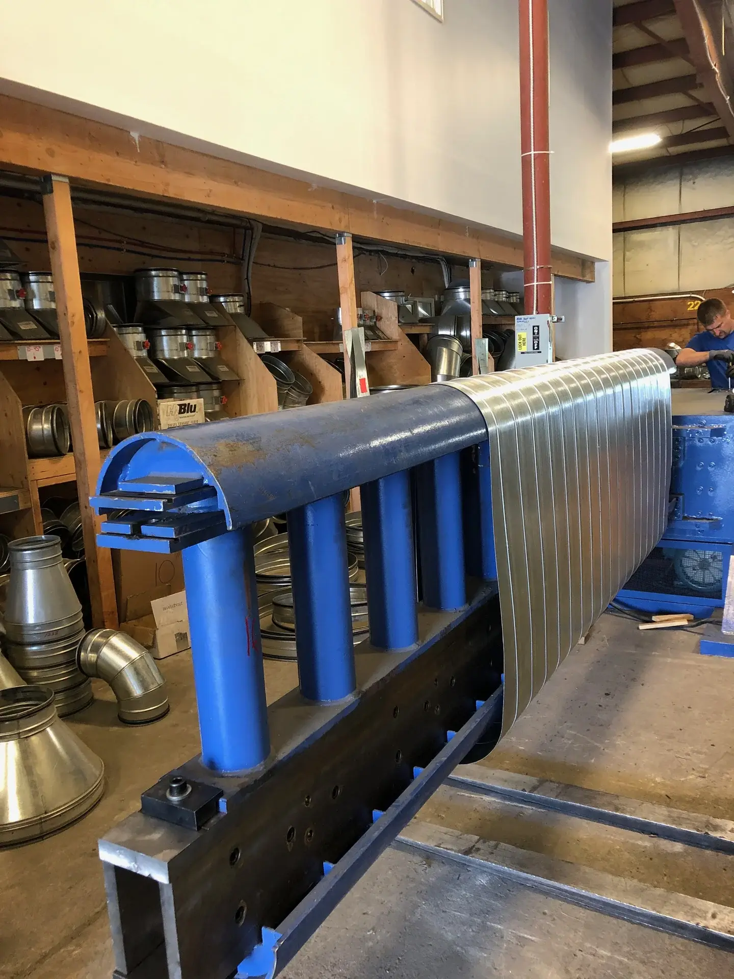 Flat oval ductwork being formed on shop machinery at Danbury Winair