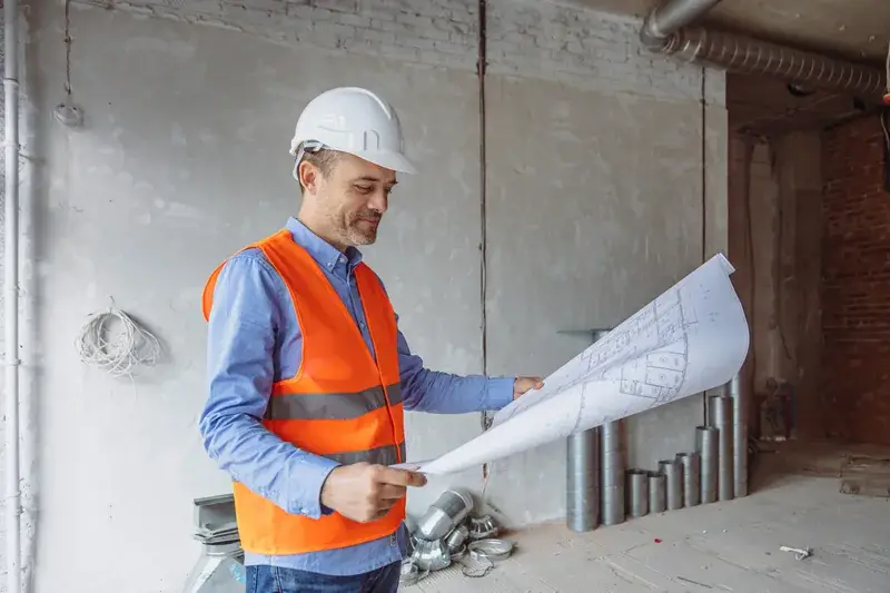 Construction professional reviewing project drawings